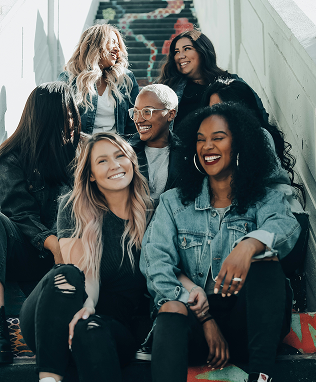 A diverse team of colleagues smiling together on stairs